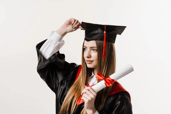 stock image Happy graduate girl smiling and holding diploma with honors in her hands on white background. Graduation. Graduate girl graduated from university and got master degree