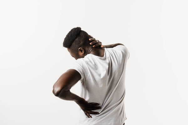 Rachiocampsis bachache and neck pain of african american man on white background. Scoliosis is sideways curvature of the spine. Rheumatism and arthritis diseases