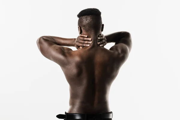 stock image Rheumatism and arthritis diseases. Rachiocampsis bachache and neck pain of shirtless african man on white background. Scoliosis is sideways curvature of the spine of muscular african american man