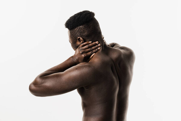 Scoliosis is sideways curvature of the spine of muscular african american man. Rheumatism and arthritis diseases. Rachiocampsis bachache and neck pain of shirtless african man on white background