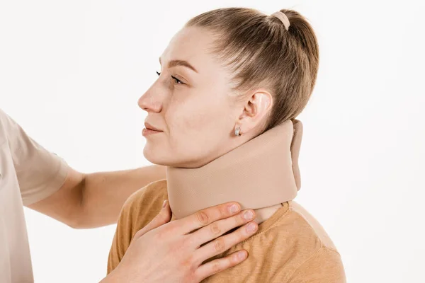 创伤专家给年轻女性戴上颈椎软领或颈圈绷带 以支撑和固定颈部或治疗创伤性头部或颈部损伤 — 图库照片