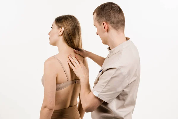 Manual therapy at physiotherapist or chiropractor. Orthopedist examining female neck and head. Manual correction of the ridge and cervical region. Rehabilitation therapy on white background