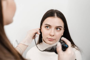 KBB doktoru kulakları incelemek ve tedavi etmek için fibrolaryngoskop kullanıyor. ENT uzmanları gırtlak ve gırtlak, gırtlak düğümleri, ses teli nodülleri, tümörler, enfeksiyonlar ve iltihaplanma gibi hastalıkları teşhis eder ve tedavi eder.