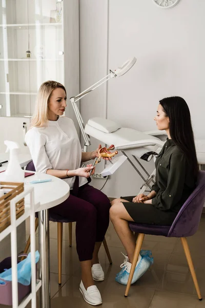 Jinekolog rahmine rahim içi aygıt IUD yerleştirme işlemi gösteriyor. Doğum kontrolünün IUD intrauterine cihaz formu hakkında jinekoloğa danışma