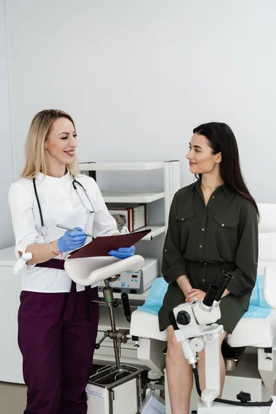 Consultation with gynecologist before colposcopy and pap test procedure to closely examine cervix, vagina and vulva of girl in gynecology clinic