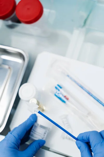 stock image Gynecologist is holding flask for cytology Pap smear test in hands. Gynecological cytology Pap smear test and cytobrush in hands of gynecologist