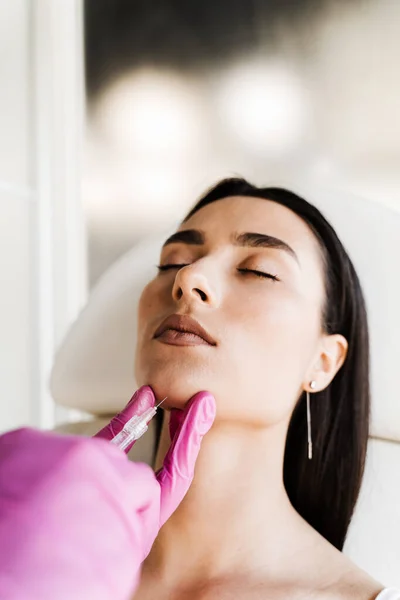 stock image Filler injection of hyaluronic acid in chin. Contour plastic for correcting the volume and shape of the chin