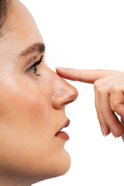 Close-up Rhinoplasty is reshaping nose surgery for change appearance of the nose and improve breathing. ENT doctor is touching nose before septoplasty surgery