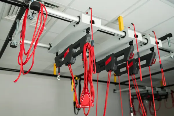 stock image Red cord equipment for athletes rehabilitation from sport injuries. Medical therapy on red straps can help to activate neuromuscular system