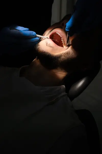 stock image Preparation to professional dental hygiene. Dental checkup. Dentist with dental mirror and explorer examine patient teeth