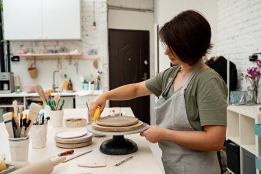 Seramik atölyesi. Kil ürünlerine daha fazla nem uygulamak. Süngerle kil yumuşatmak. Çömlekçilik dersi için sünger kullanıyorum. Aşırı nemden kurtulmak için sünger emiyor.