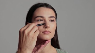 Rhinoplasty burun ameliyatı 4K videosuna hazırlanıyorum. Estetik cerrah, dış burun ve çevresindeki yapılar üzerinde burun ameliyatı planına işaret koyuyor. Burun büyüklüğü ve orantısının doğru değişimi