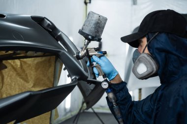 Araç bakım servisindeki arabaları boya spreyiyle boyamak. Araba boyacısı metali boyamak için HVLP ya da LVLP sprey tabancası kullanıyor.