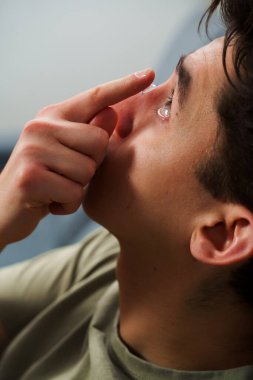 Göz teması lensleriyle göz doktorunun seçtiği görüş düzeltmesi. Adam görüş düzeltmesi için günlük kontak lens takıyor.