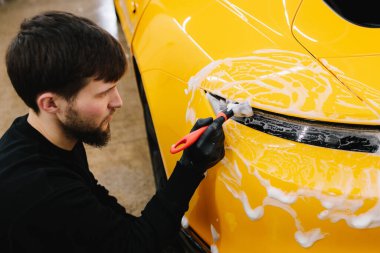 Farları köpük ve yumuşak fırçayla yıkama prosedürü. Araba yıkamada temizlik fırça ve köpükle yapılır.