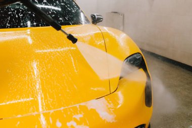 Araba yıkamada su tabancasından araba yıkama işleminin ayrıntıları su tabancasından arabaya kadar olan basınç altında su uygulanması.