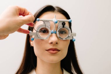 Doğru reçeteli lensleri belirlemek için deneme çerçevesi gözlüğü. Göz muayenesi için göz doktorunun deneme çerçevesi gözlüğü takıyor.