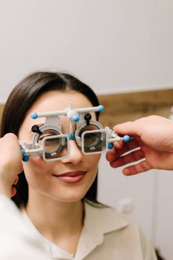 Doğru reçeteli lensleri belirlemek için deneme çerçevesi gözlüğü. Göz muayenesi için göz doktorunun deneme çerçevesi gözlüğü takıyor.