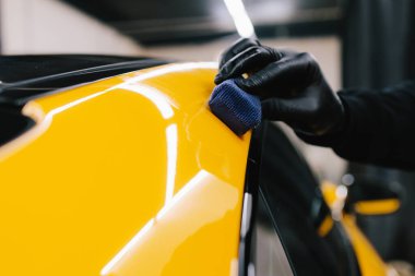 Seramik kaplama işlemi, servisteki detaylı oturum sırasında korunmak için spor araba yüzeyine uygulanır. Araba servisinde seramik cilalama ayrıntıları