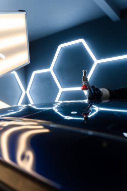 Göçük arkasından kullanılan PDR çubuk aracı klasik tamir tekniğini gösterir. Araba panelinin içinden acısız tamir aletleri çalışıyor. Teknisyen çeliği tamir etmek için koz çubuğu kullanıyor.