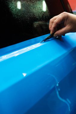 Keskin bıçaklı PPF budama. Vinil ambalaj detaylarında bıçak budamak mükemmellik için çok önemlidir. Keskin bıçak detaylandırma sürecini sonuçlandırmak için kullanılır, PPF paketini tam hassasiyetle keser