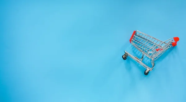shopping cart with empty blue background
