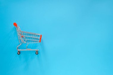 shopping cart with empty blue background