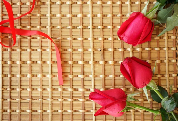 stock image red tulips and a heart on a wooden background