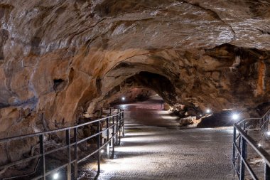 An illuminated tunnel in Goughs Cave in Cheddar in Somerset