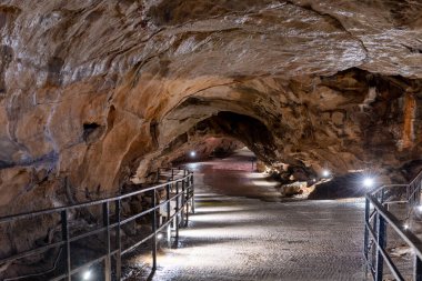 An illuminated tunnel in Goughs Cave in Cheddar in Somerset