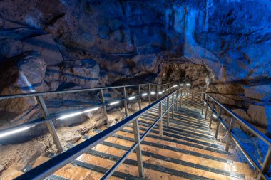 An illuminated staircase inside Goughs Cave in Cheddar in Somerset