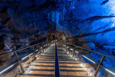 An illuminated staircase inside Goughs Cave in Cheddar in Somerset