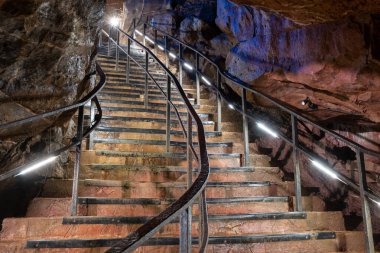 An illuminated staircase inside Goughs Cave in Cheddar in Somerset
