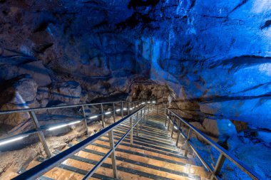An illuminated staircase inside Goughs Cave in Cheddar in Somerset