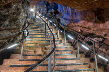 An illuminated staircase inside Goughs Cave in Cheddar in Somerset