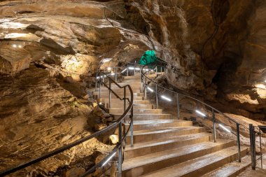 An illuminated staircase inside Goughs Cave in Cheddar in Somerset