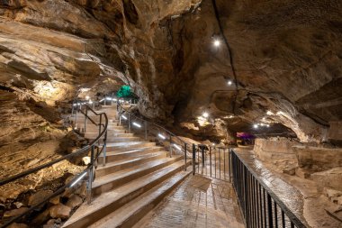 An illuminated staircase inside Goughs Cave in Cheddar in Somerset