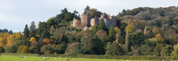 Panoramic photo of the autumn colours at Dunster castle in Somerset