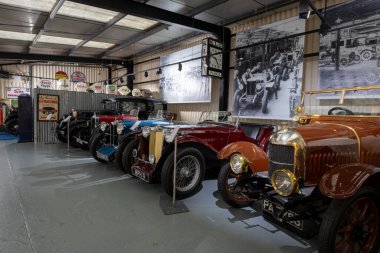 Sparkford.Somerset.United Kingdom.March 26th 2023.A row of vintage cars including a Morris Cowley Bullnose from 1917 are on show at the Haynes Motor Museum in Somerset clipart