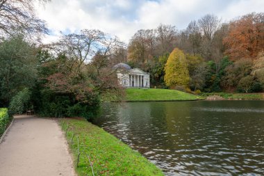 View of the autumn colours around the lake at Stourhead gardens in Wiltshire clipart