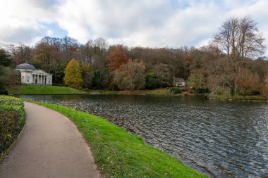 View of the autumn colours around the lake at Stourhead gardens in Wiltshire clipart
