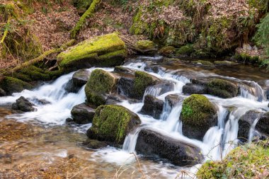 Long exposure of a waterfall on the Hoar Oak Water river at Watersmeet in Exmoor National Park clipart