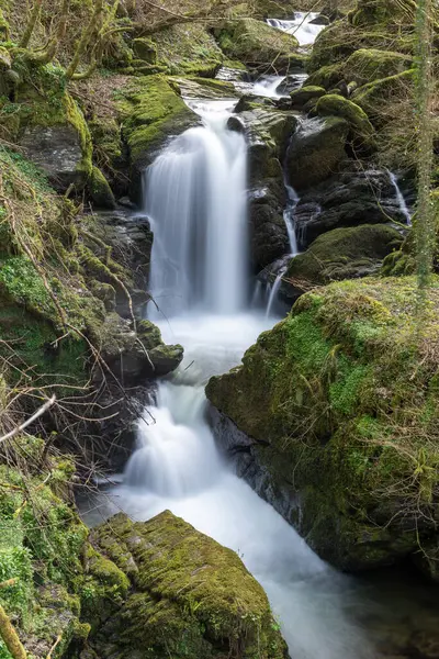 Stock image Long exposure of a waterfall on the Hoar Oak Water river at Watersmeet in Exmoor National Park