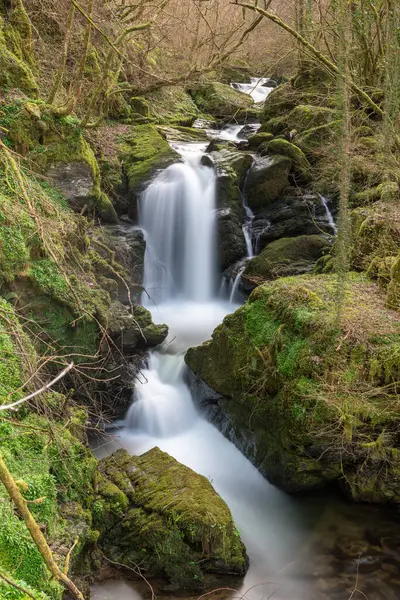 stock image Long exposure of a waterfall on the Hoar Oak Water river at Watersmeet in Exmoor National Park