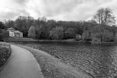 Black and white photo of the Pantheon and the Gothic Cottage around the lake at Stourhead gardens in Wiltshire clipart