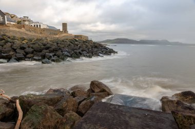 The mouth of the river Lim flowing into the English Channel at Lyme Regis in Dorset clipart