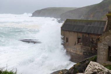 Rough seas at the Lizard Point in Cornwall during storm Kathleen on April 6th 2024 clipart