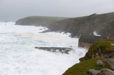 Rough seas at the Lizard Point in Cornwall during storm Kathleen on April 6th 2024 clipart