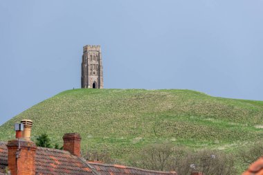 View from the street of Glastonbury tor in Somerset clipart