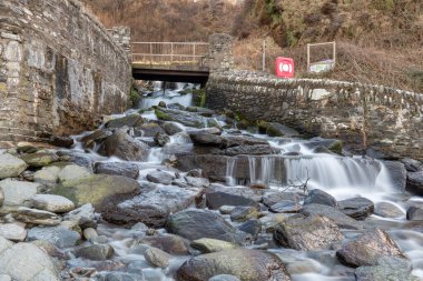 Long exposure of a waterfall flowing onto Lee Abbey Beach in Devon clipart